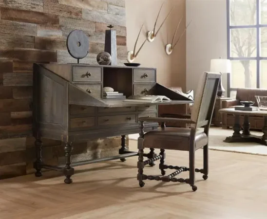Rustic wooden desk with chair and decor items.
